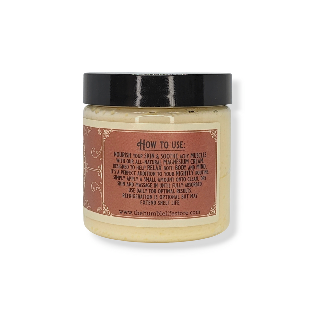 Jar of cream with a black lid and brown label on a white background