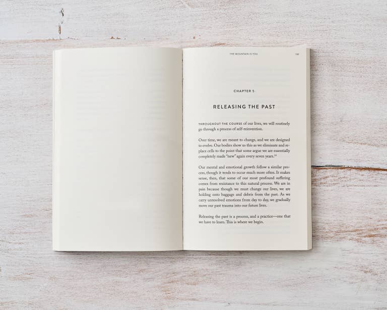 Open book on a wooden surface with text visible