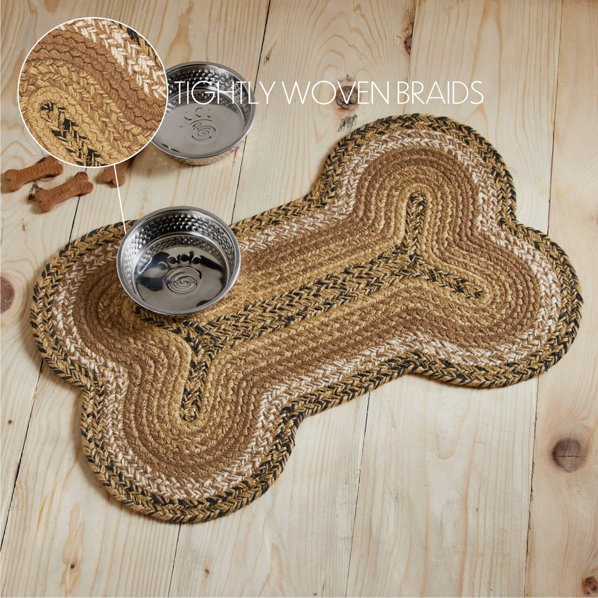 A braided pet bed mat in a bone shape, shown on a light wood plank floor with two metal bowls and a circular inset showing the tightly woven braids detail.
