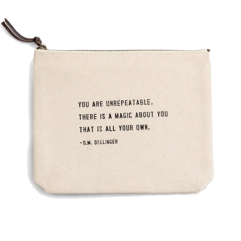 Beige pouch with motivational quote on a white background