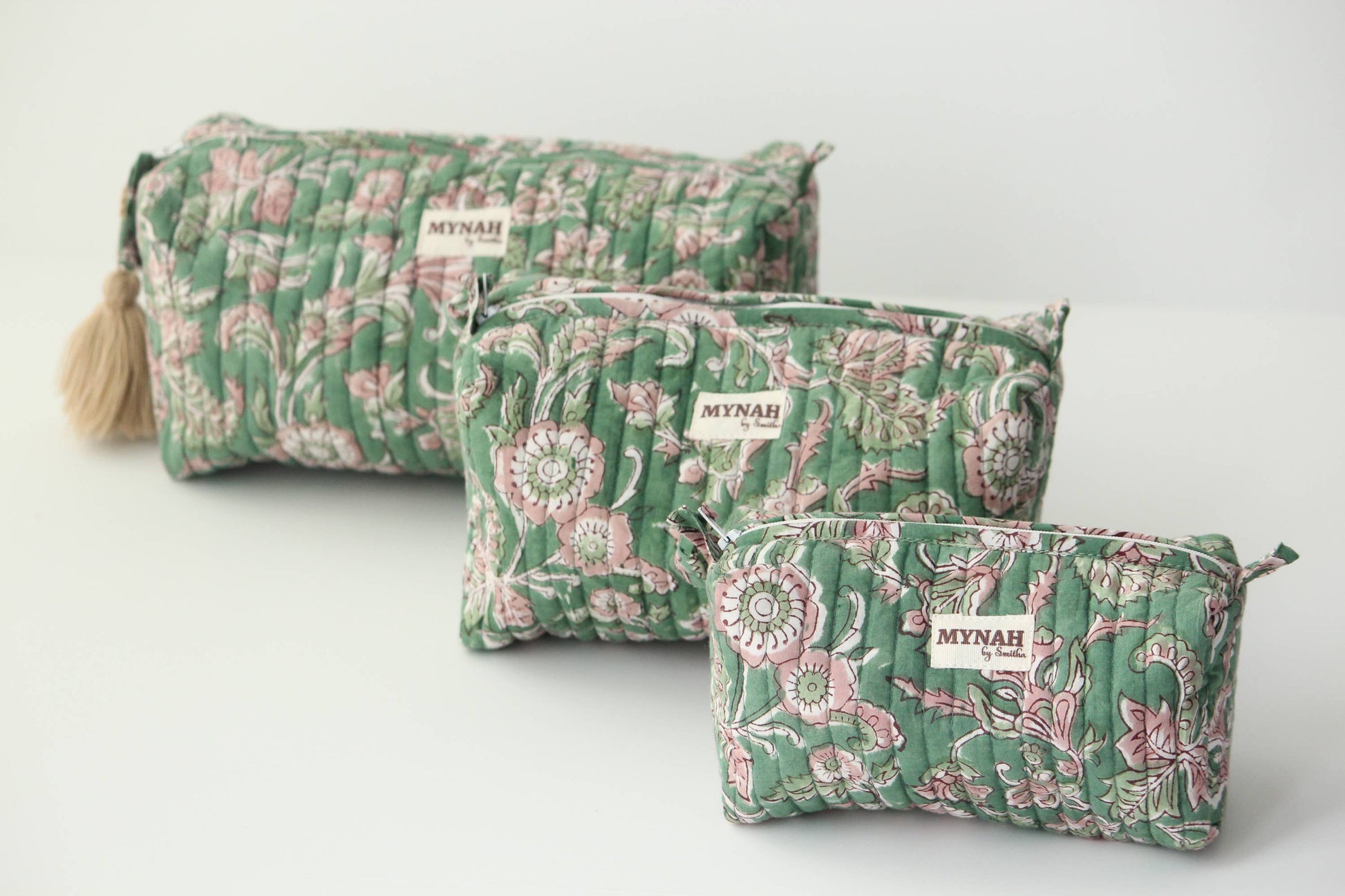 Set of three green floral-patterned bags with 'Myrah' branding on a light gray background