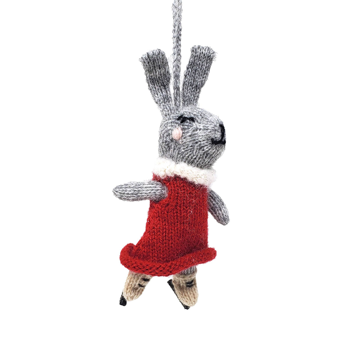 Knitted rabbit ornament with a red dress on a white background