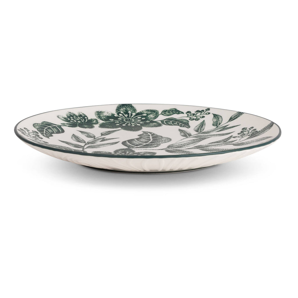 A round ceramic serving platter with a white base decorated with a dark green botanical floral pattern, shown on a clean white background.