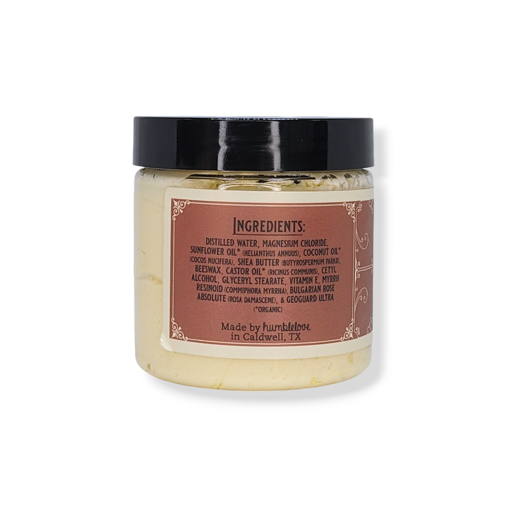 Jar of cream with a label showing ingredients on a white background