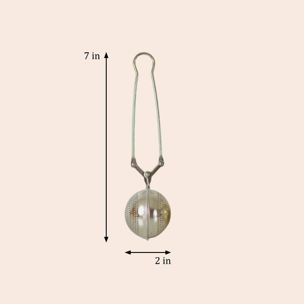 Tea ball with dimensions labeled on a beige background