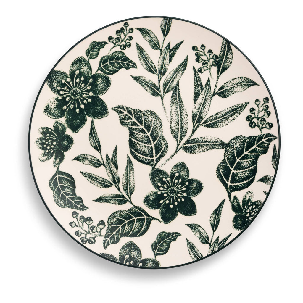 A round ceramic plate with a dark green botanical floral pattern on a warm cream background, featuring a thin black rim.