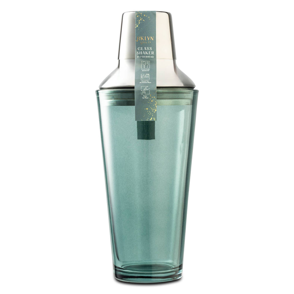 A cobalt blue glass shaker with a matching metal lid and a decorative paper tag, shown on a solid white background.