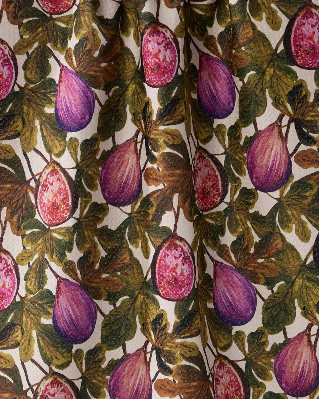 A close-up of a fabric or wallpaper pattern featuring purple figs and green-brown leaves on a cream background.