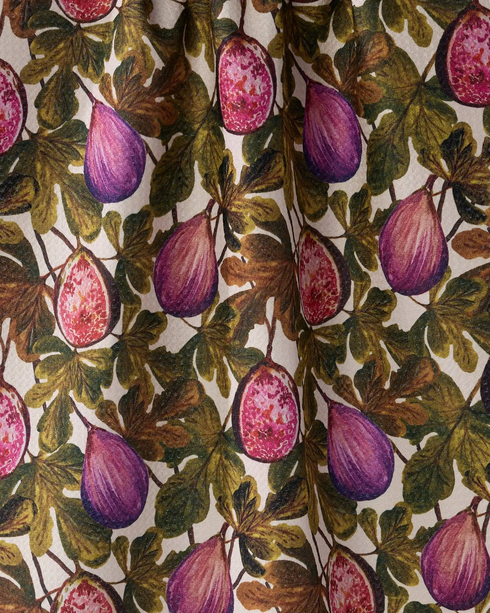 A close-up of a fabric or wallpaper pattern featuring purple figs and green-brown leaves on a cream background.