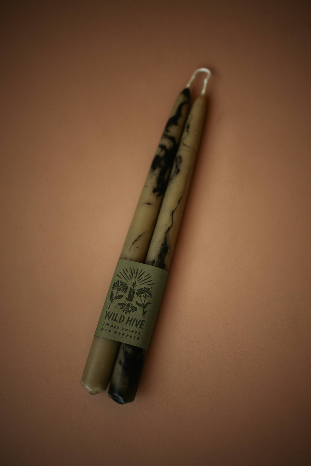 Two candles with a label on a brown background