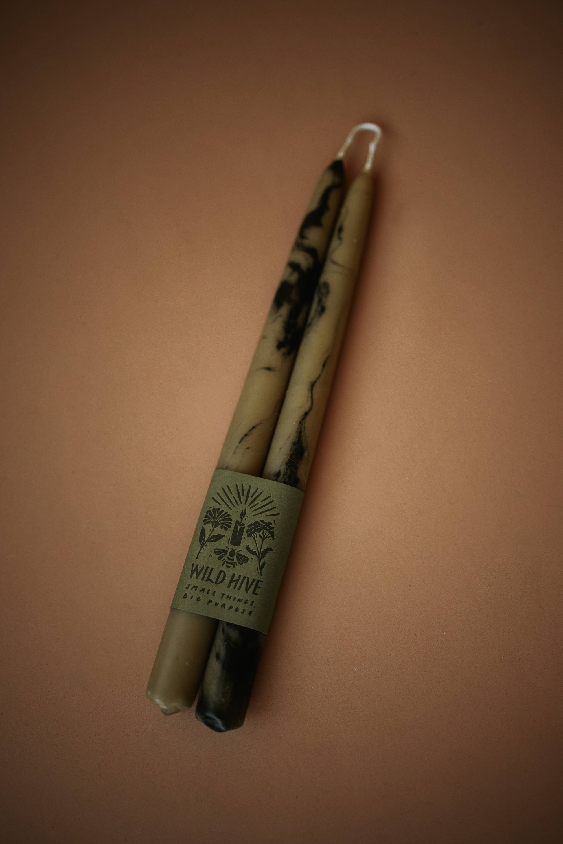 Two candles with a label on a brown background