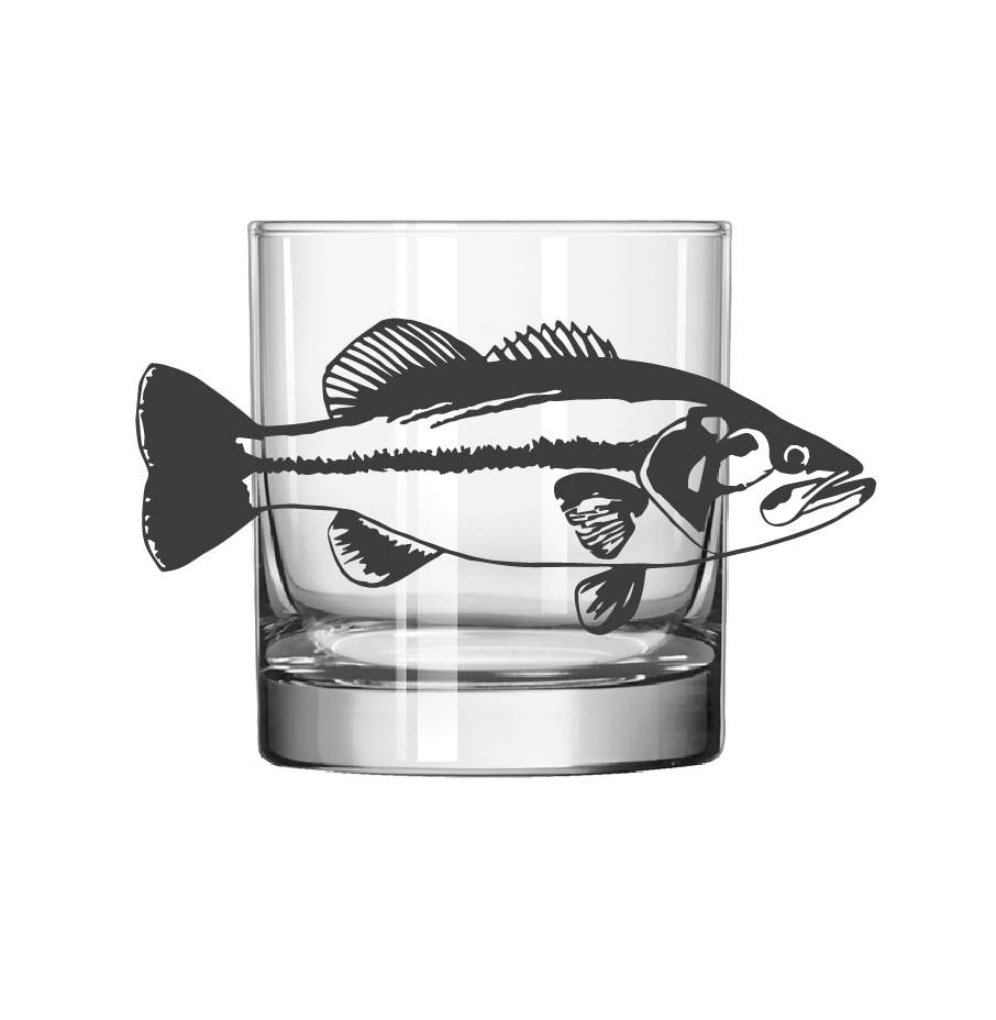 A clear glass tumbler with a black fish silhouette printed across the front, shown on a plain white background.