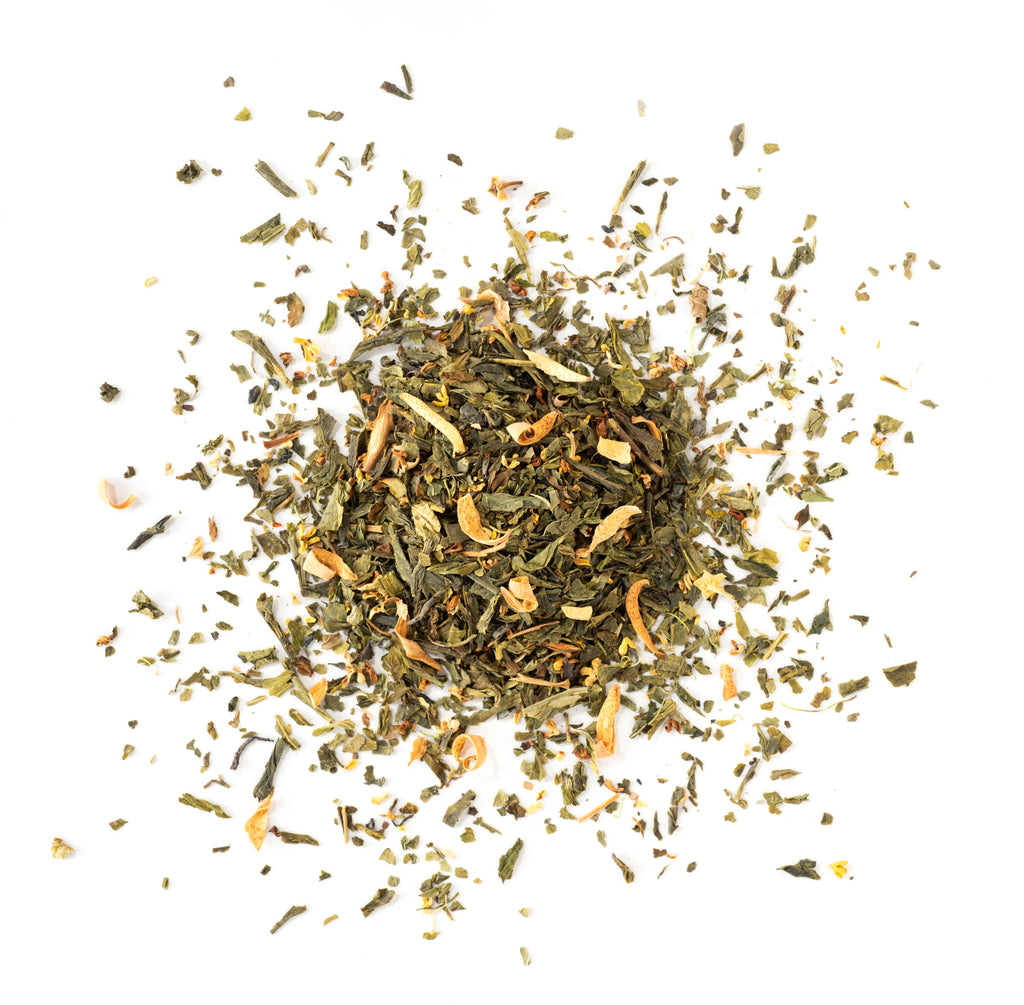 Dry green tea leaves on a white background