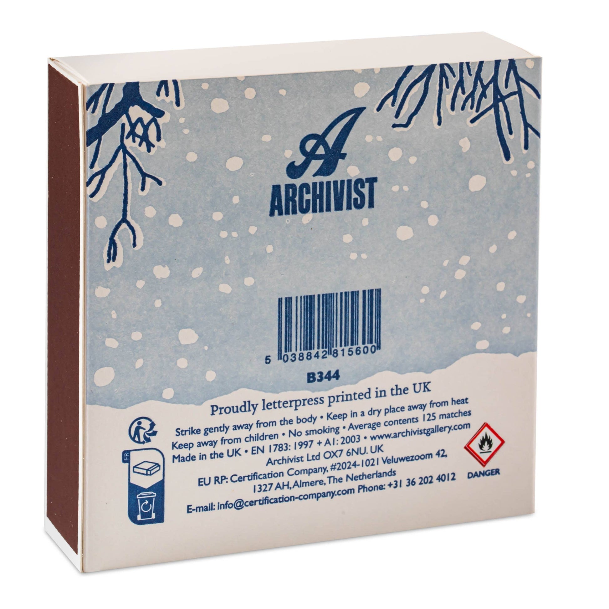 Back view of a boxed product for Archivist, showing a pale blue winter-themed package with dark blue tree branches, white snowflakes, a barcode, and small certification icons on a white background.