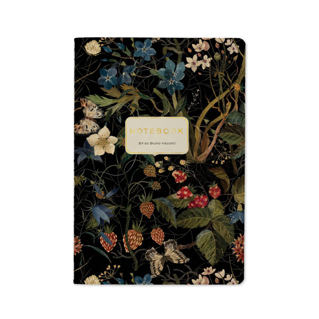 A floral notebook with a black background and an intricate botanical pattern of blue, red, and white flowers with green leaves. A cream-colored label in the center reads 'NOTEBOOK' with 'By Bruna Visconti' underneath.