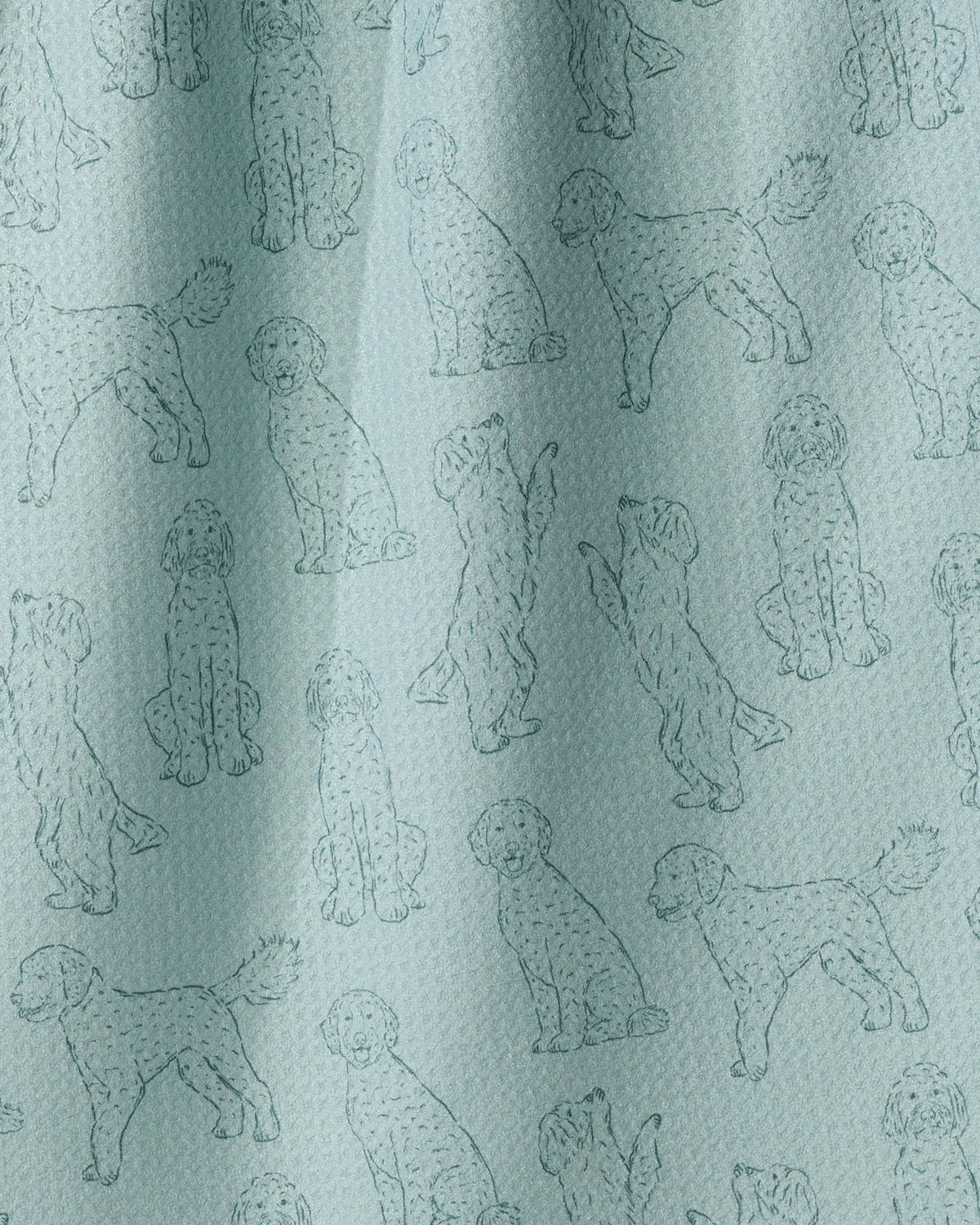 A close-up of a light blue fabric with an all-over repeating pattern of poodle illustrations in a slightly darker blue-gray outline.