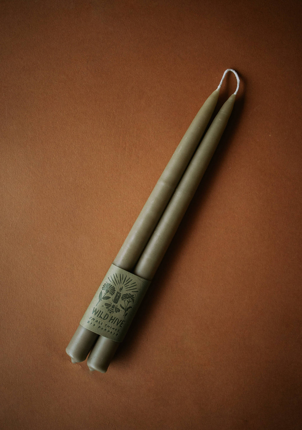 Set of wooden chopsticks with a branded sleeve on a brown background