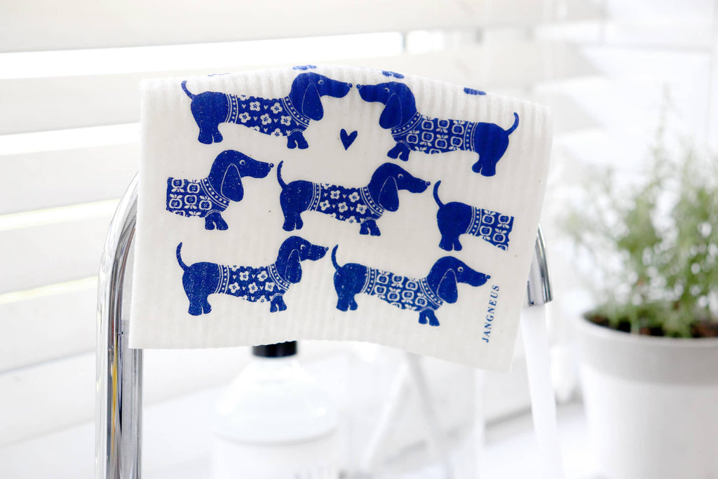Fabric with blue dachshund pattern on a white background