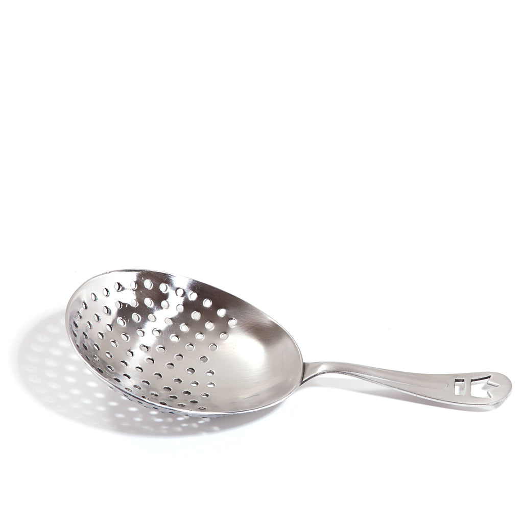 Metallic skimmer spoon with holes on a white background