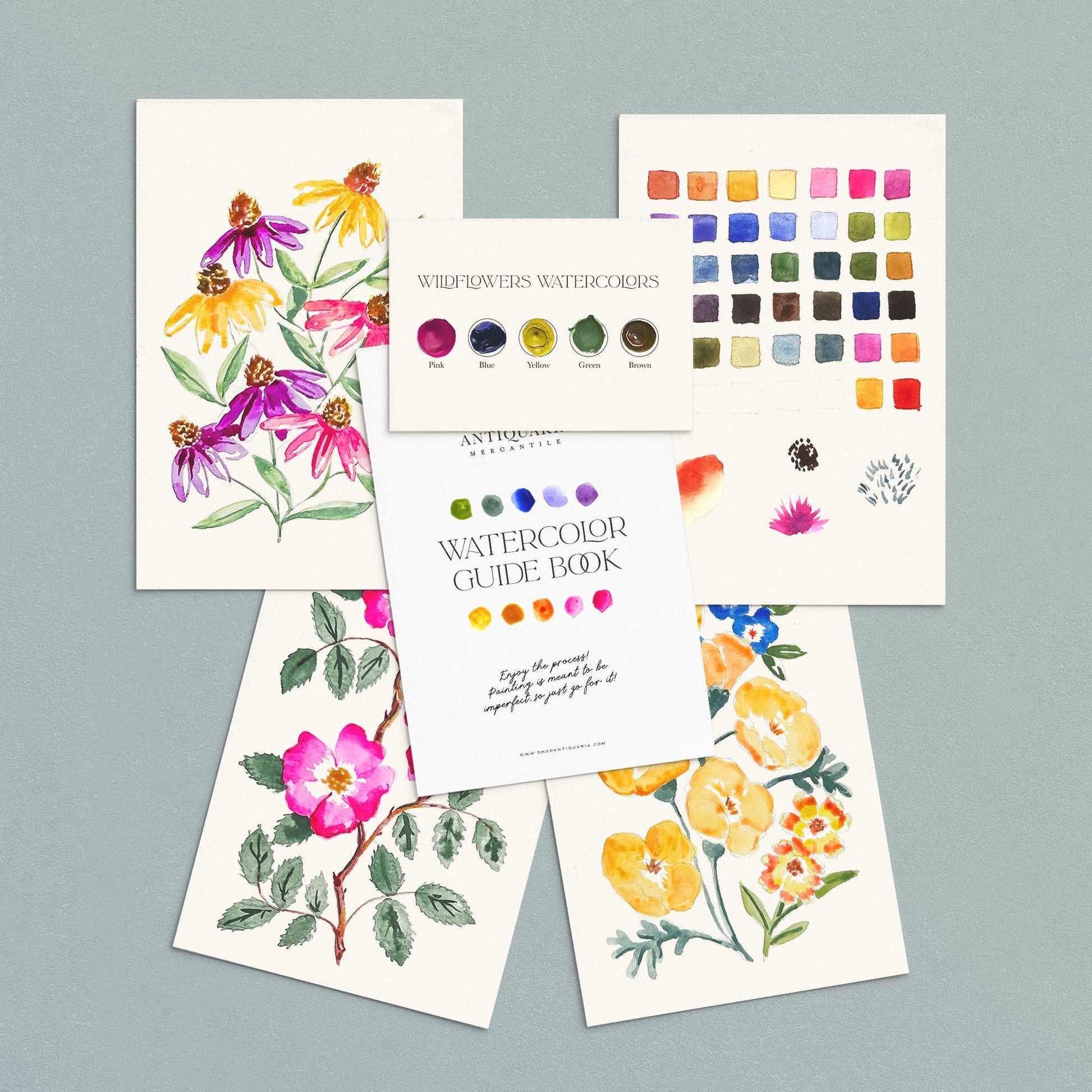 Set of watercolor cards with floral designs and a color swatch on a gray background
