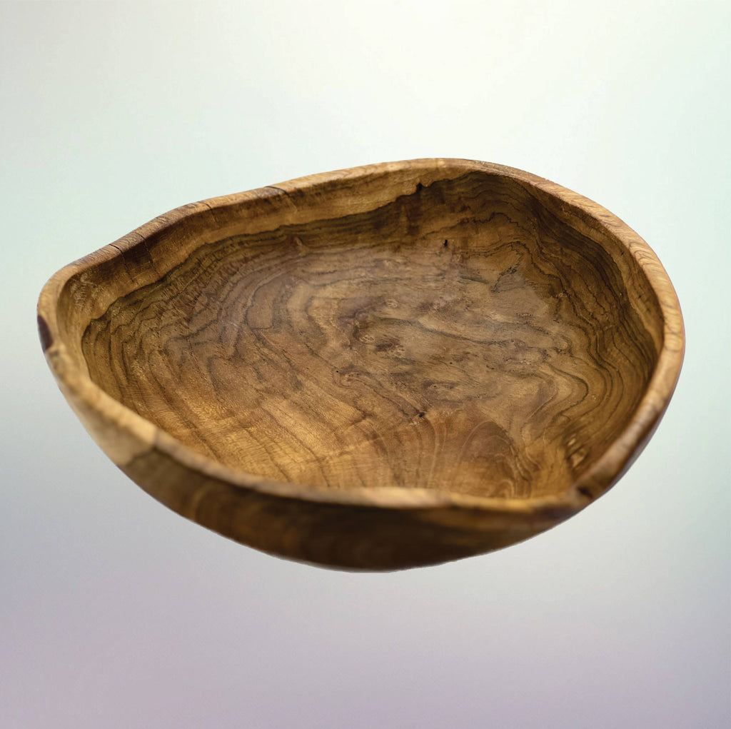 A rustic handcrafted wooden bowl with a natural irregular edge and prominent wavy wood grain patterns, shown against a light gray gradient background.