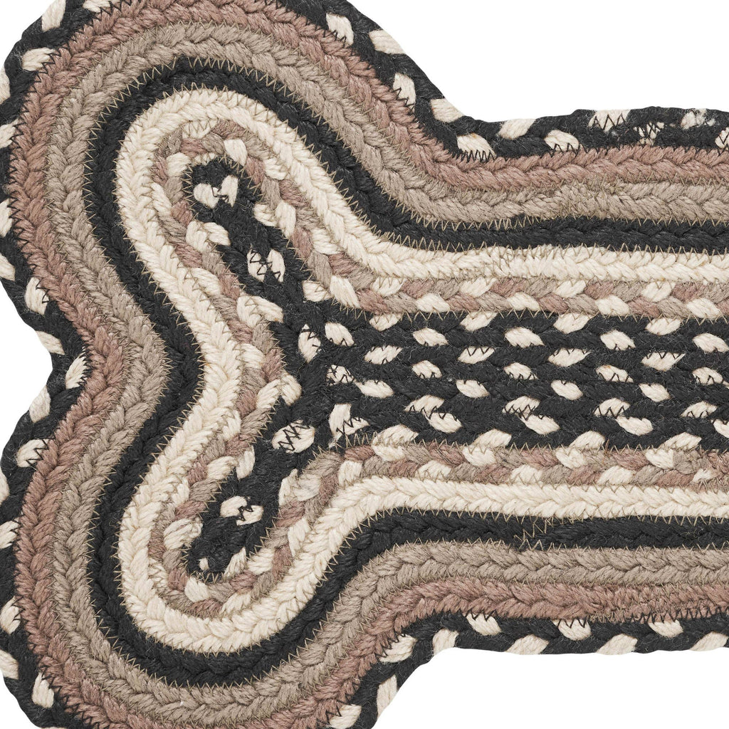 Close-up of a braided rug with wavy pattern on a white background