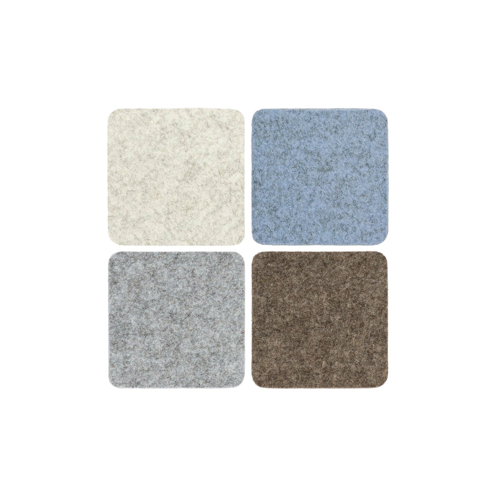 Four square samples of different textured fabric colors on a white background