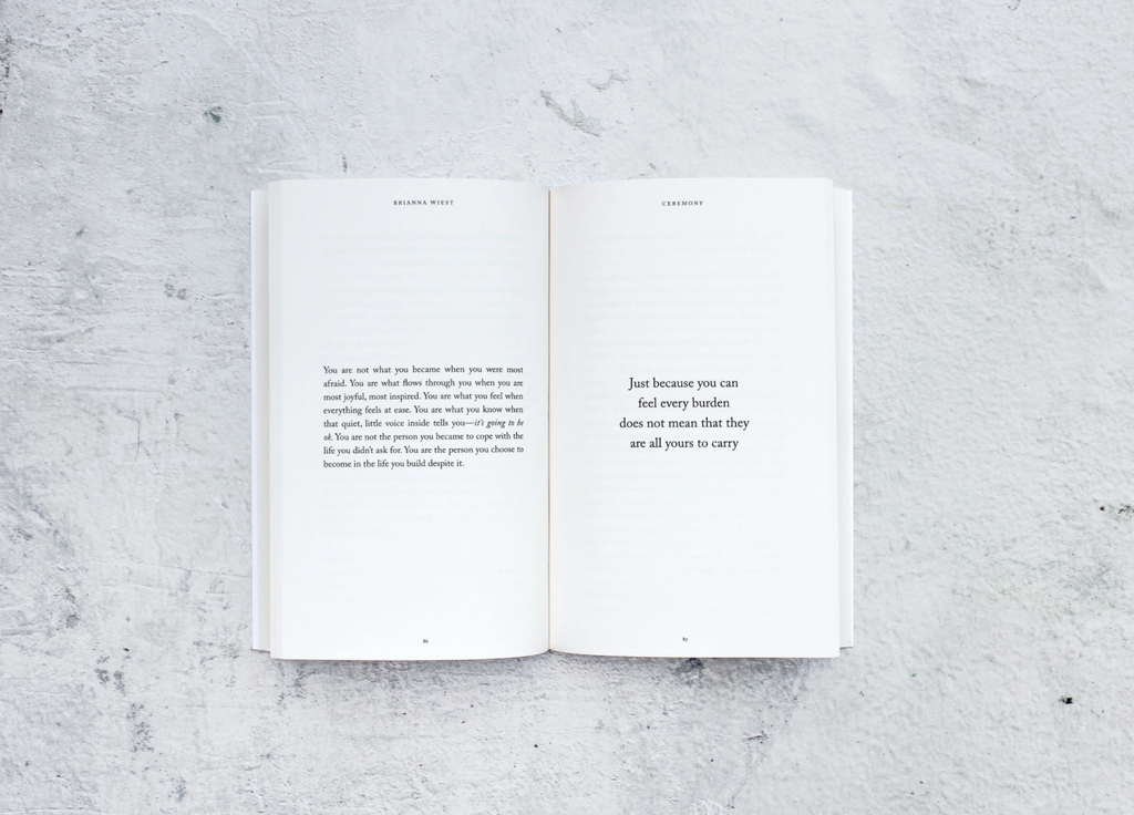 Open book with text on a textured gray surface