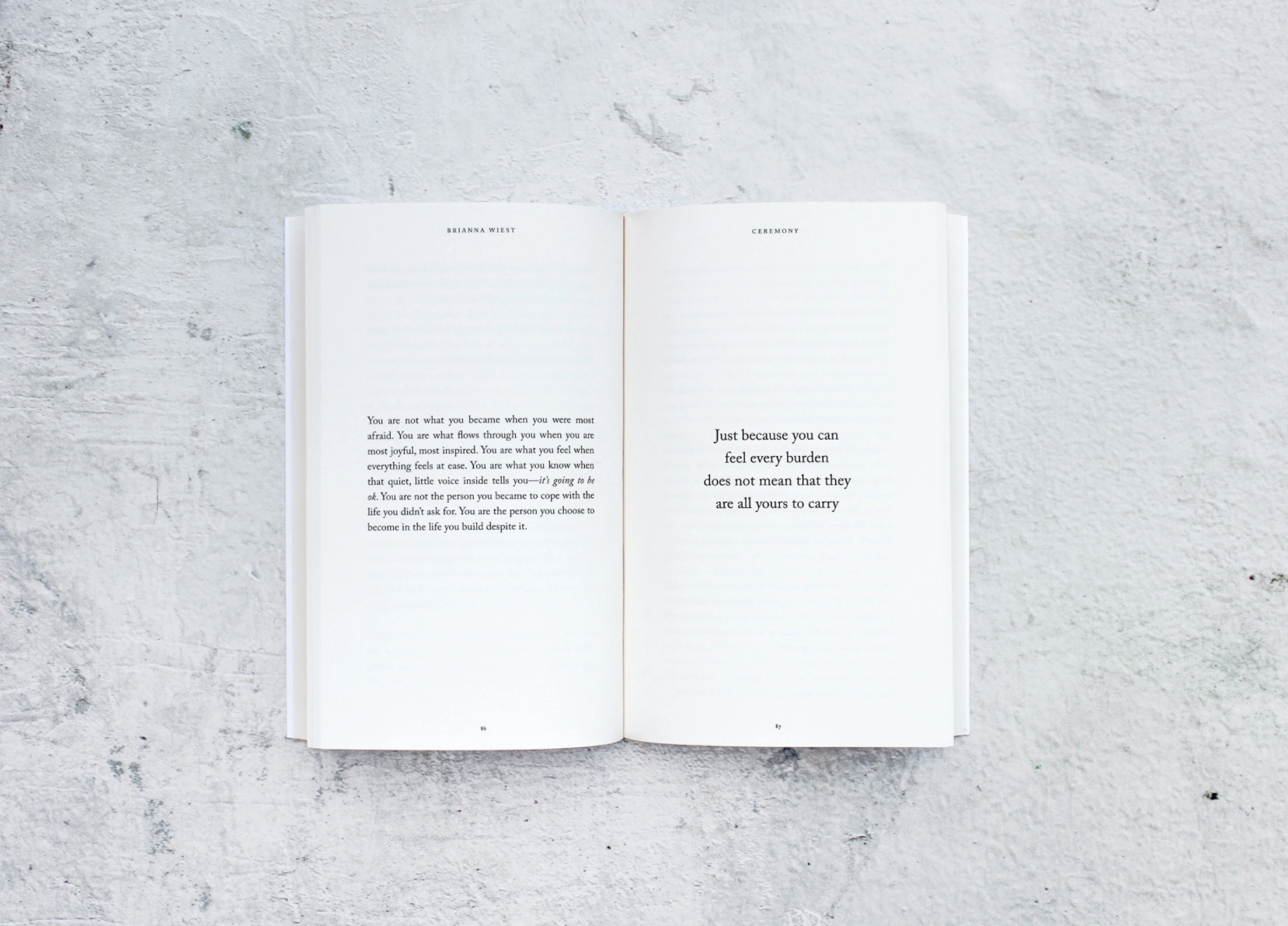 Open book with text on a textured gray surface