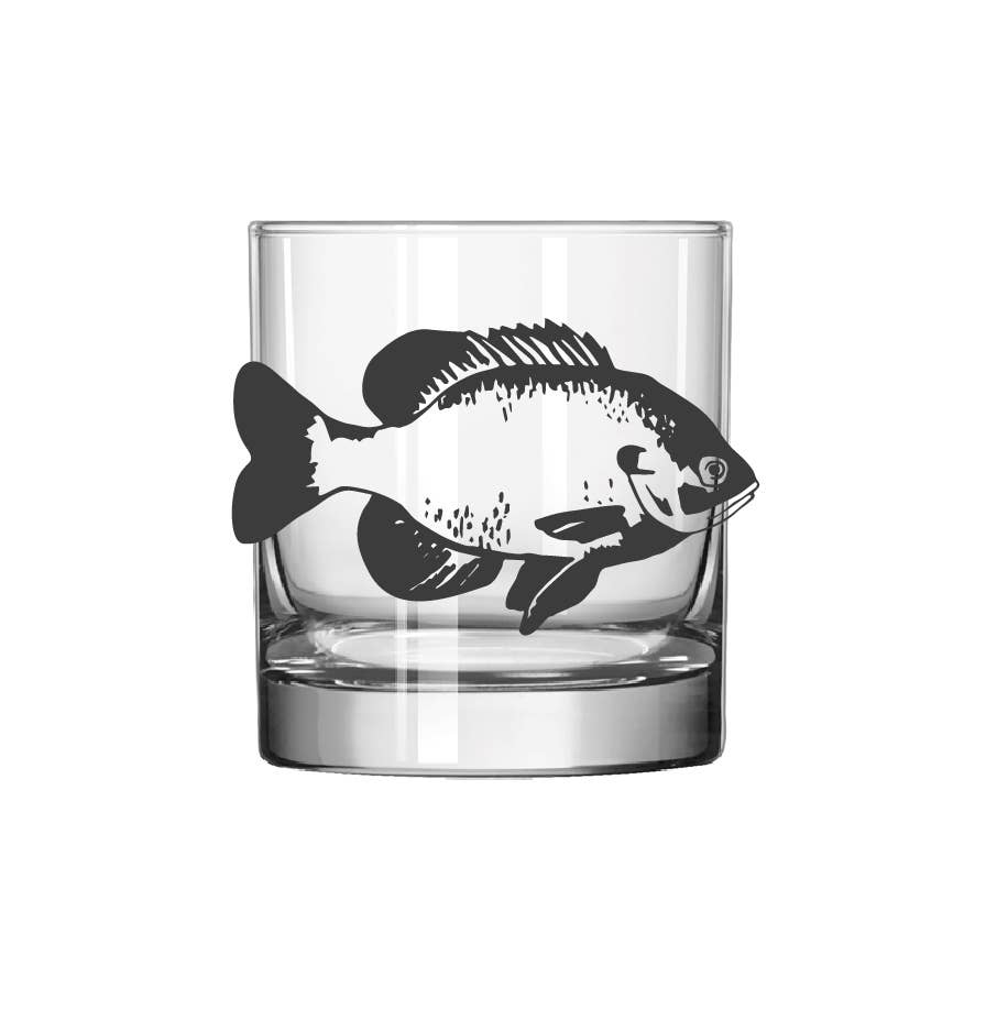 A clear glass rocks tumbler featuring a black fish silhouette printed on the side, shown against a plain white background.