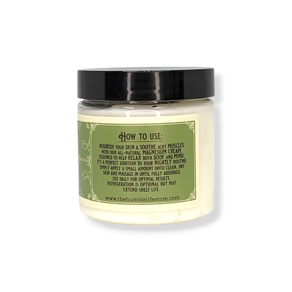 Jar of cream with a black lid and green label on a white background