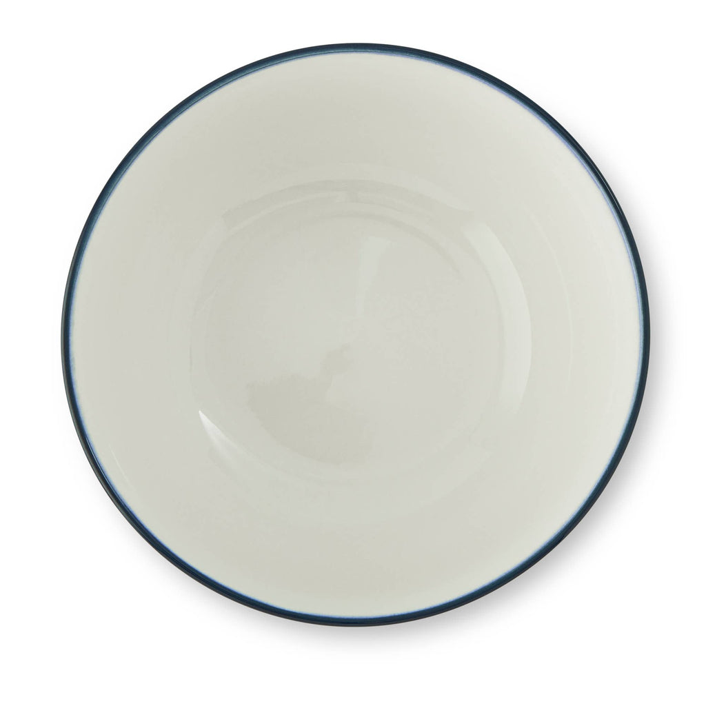 A top-down view of a round white ceramic plate with a thin dark blue rim, set against a plain white background.