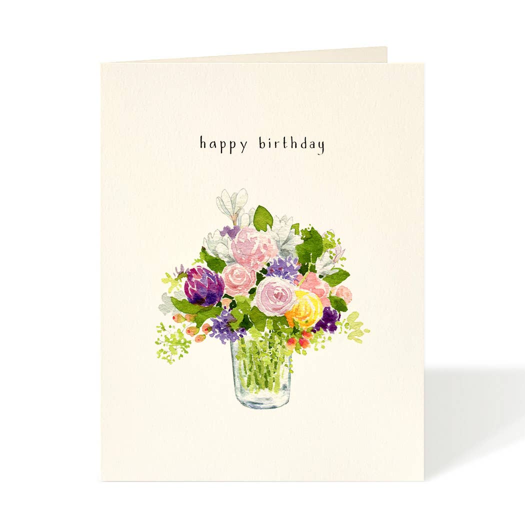 A cream-colored greeting card with the words 'happy birthday' printed in a simple black font above a watercolor-style bouquet of pink, purple, yellow, and white flowers in a glass vase, shown on a white background.