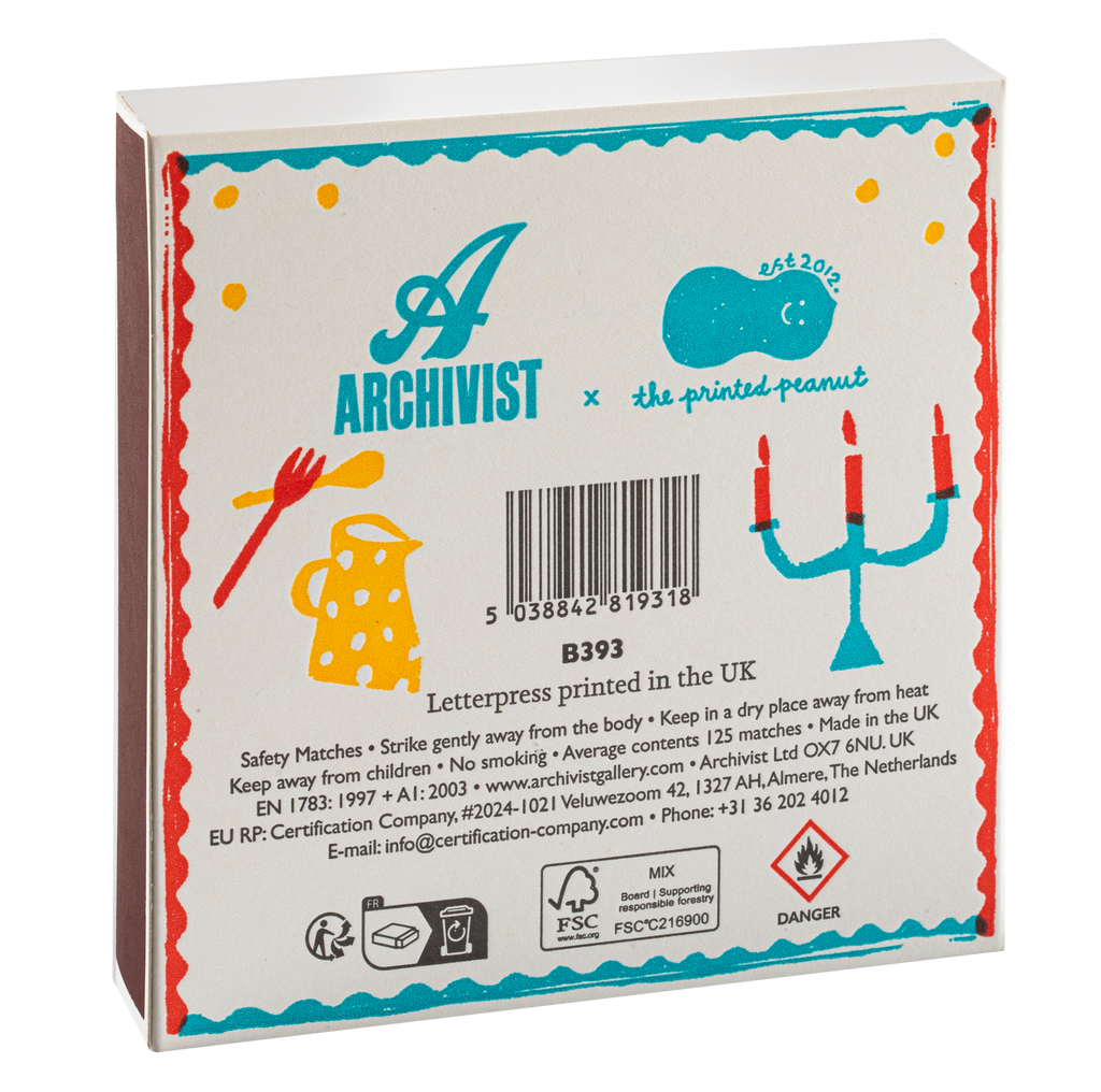 The back of a white Archivist x The Printed Peanut letterpress box, featuring colorful illustrations of a candelabra, a yellow polka-dot hat, and safety information, photographed on a white background.