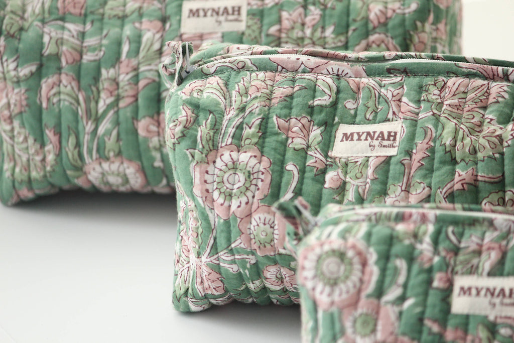 Floral patterned pouches with 'Mynah' branding on a light background