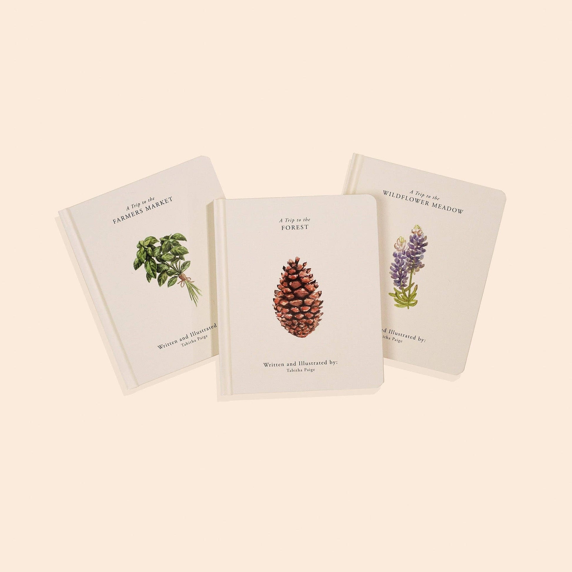 Three books with nature-themed illustrations on a beige background