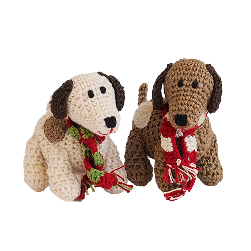 Two crocheted dog toys with scarves on a white background