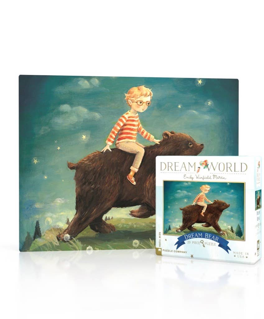 Dream Bear jigsaw puzzle and its retail box by Emily Wildfield Morris, featuring an illustration of a young boy riding a large brown bear under a starry night sky.