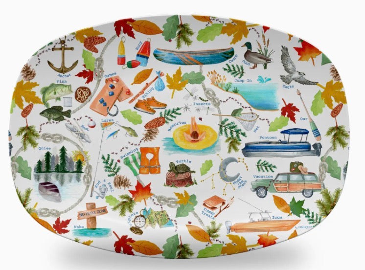 An oval white serving platter decorated with a colorful, whimsical outdoor and autumn-themed illustration pattern featuring leaves, boats, a canoe, a duck, a car, and other nature motifs.