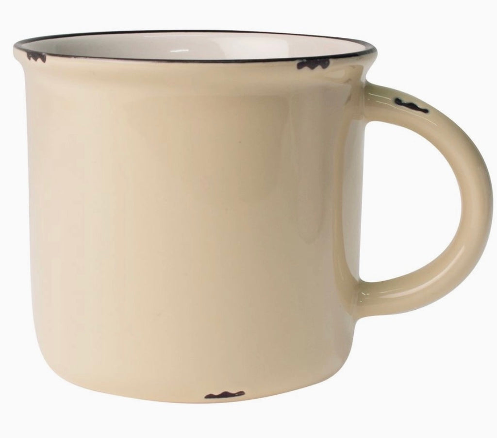 A cream-colored ceramic mug with a black rim and small black distressed accents on the handle and exterior, shown against a plain white background.