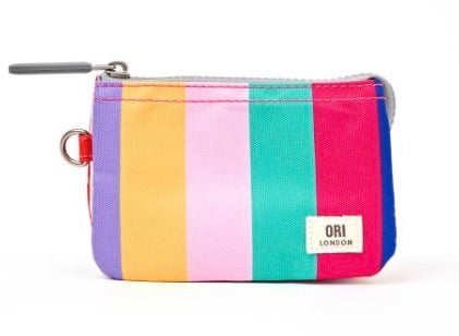 A small zippered pouch with vertical rainbow stripes in purple, yellow, pink, teal, and magenta, featuring a white ORI LONDON brand patch on the front.