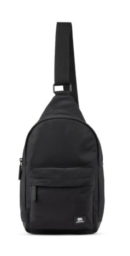 A black nylon sling backpack with an adjustable shoulder strap and a small white logo on the bottom right corner, shown against a plain white background.