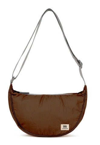 A brown crescent-shaped shoulder bag with a thin gray strap and a small white ORI London brand label on the front, set against a plain white background.