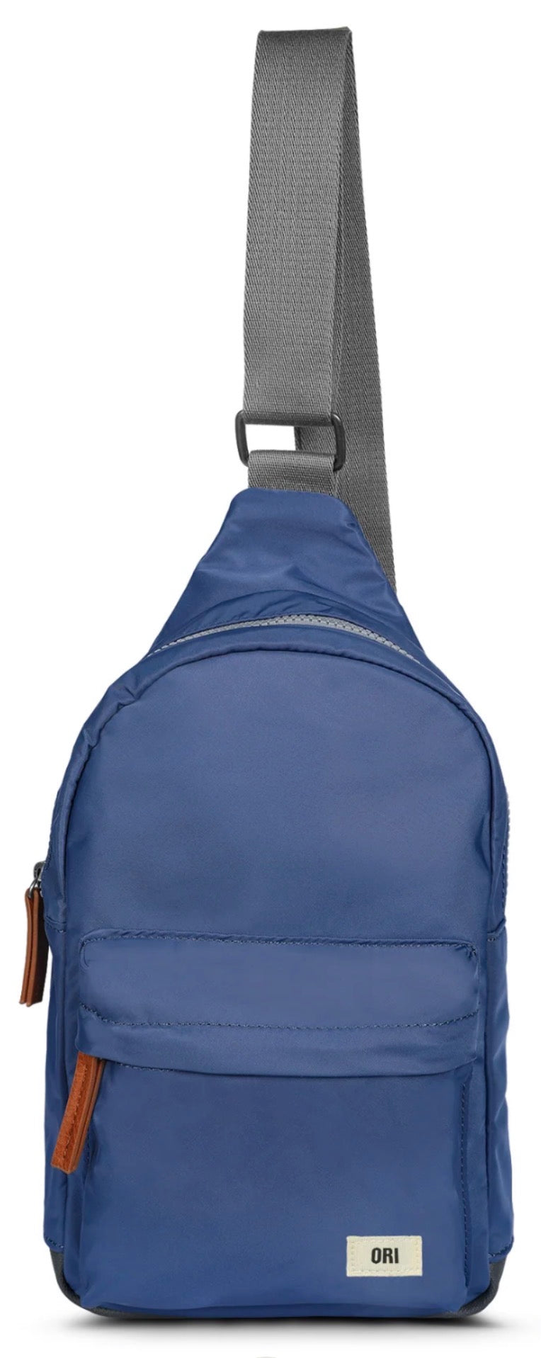 A blue nylon sling backpack with a gray adjustable shoulder strap, featuring a front zippered pocket and a small white brand label at the bottom right.