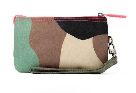 A small zippered wristlet pouch with an abstract wavy color-block pattern in sage green, brown, black, and cream, featuring a matching green wrist strap and a pink zipper pull.