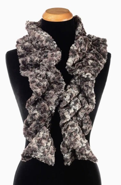 A chunky, ruffled faux fur scarf in a mottled gray and black pattern, displayed on a black mannequin torso against a white background.