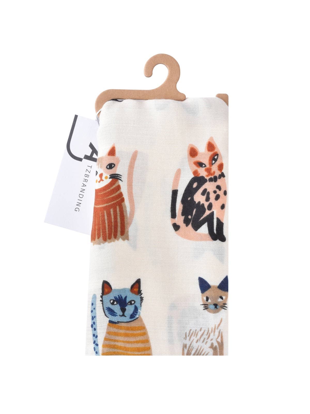 Fabric with cat illustrations on a hanger against a white background