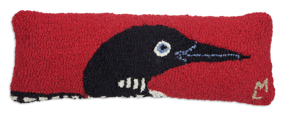 Decorative pillow with a black bird design on a red background