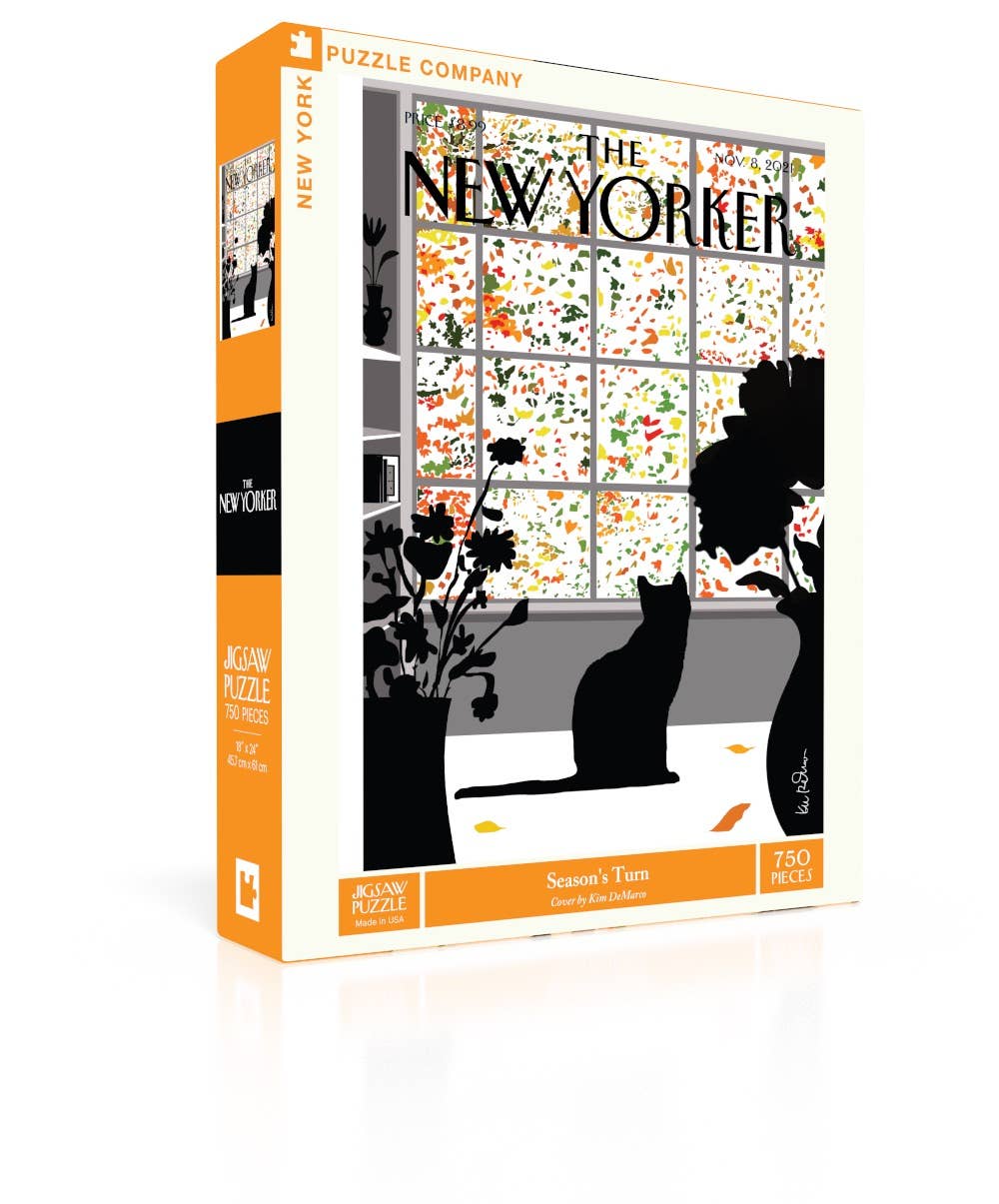 A jigsaw puzzle box for 'The New Yorker' featuring a winter scene with a cat silhouette, flowers, and a window. The box is white with orange side panels and black text, shown on a clean white background.
