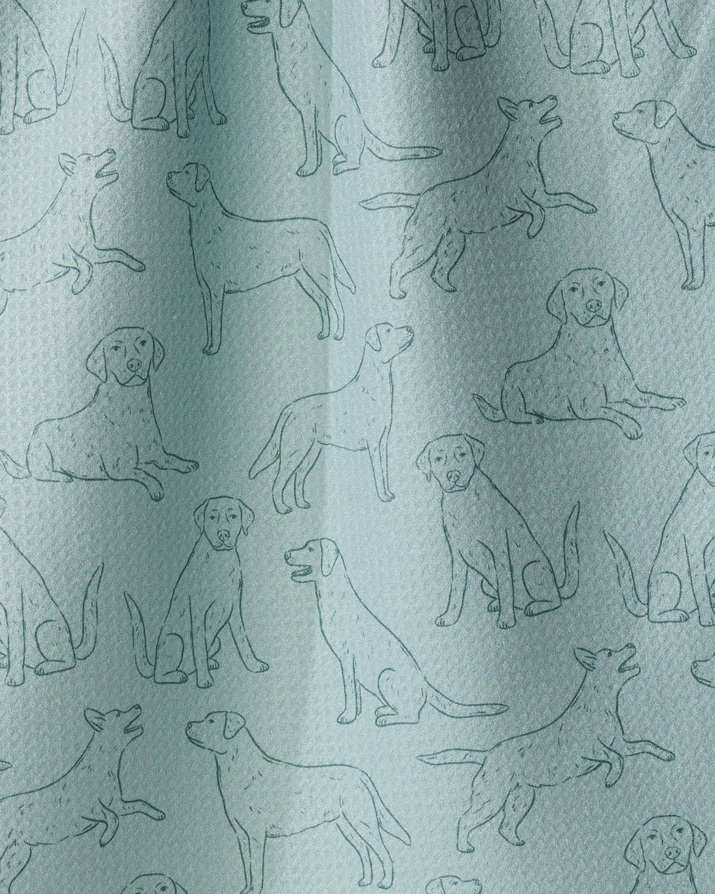 A close-up of a light blue-green fabric with an all-over repeating pattern of dog silhouettes in a slightly darker blue-green tone.